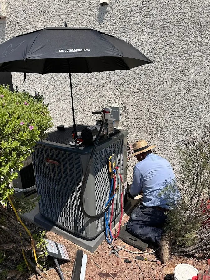 HVAC technician performing outdoor AC maintenance in Peachtree City